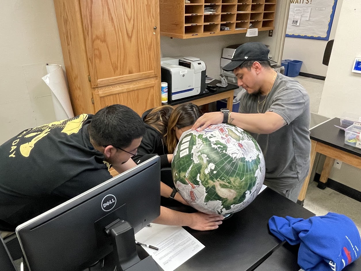 GEOL 3090 students measure distances on a globe